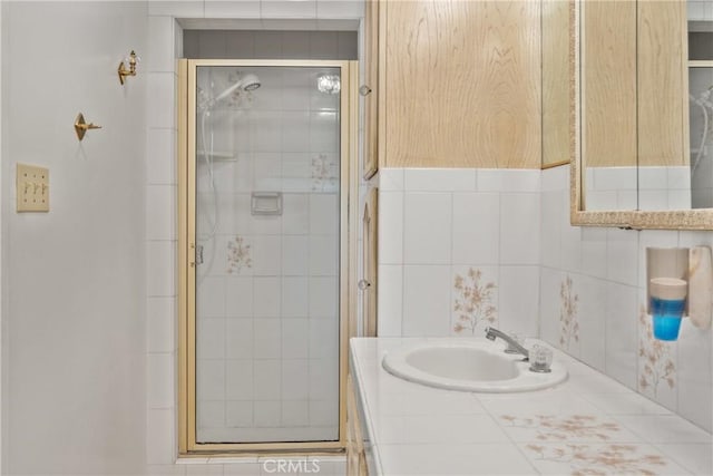 bathroom featuring vanity and a shower with door