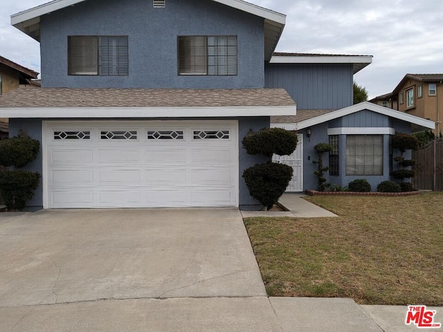 view of front of house featuring a front yard and a garage