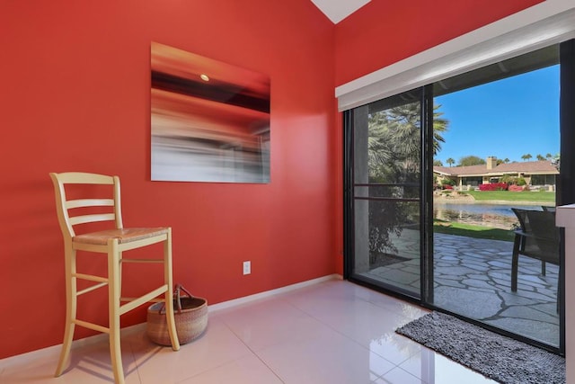 entryway featuring tile patterned floors and a water view