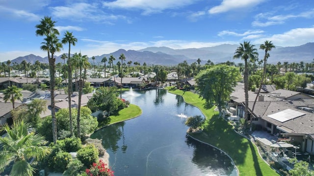 birds eye view of property with a water and mountain view