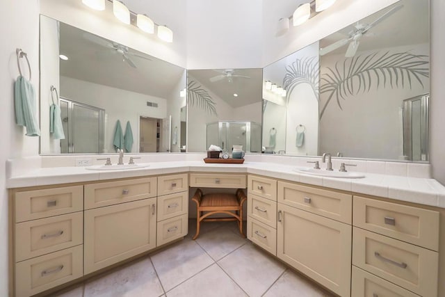 bathroom featuring vanity, vaulted ceiling, tile patterned floors, and walk in shower