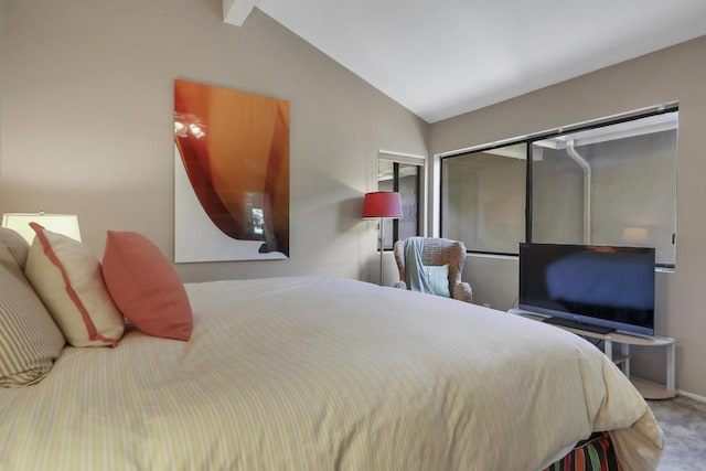 bedroom with a closet, carpet, and lofted ceiling with beams