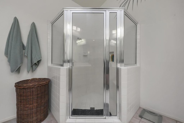 bathroom with walk in shower and tile patterned floors