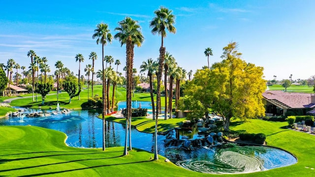 view of home's community with a water view and a lawn