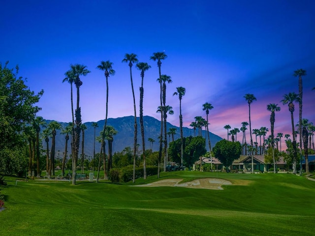 surrounding community with a lawn and a mountain view