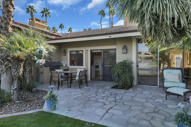 back of property with a patio