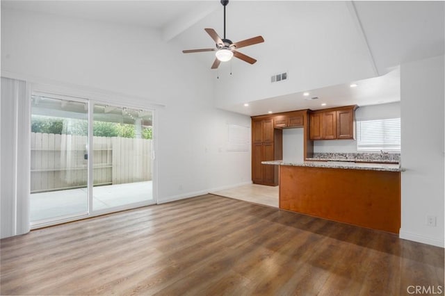 kitchen with ceiling fan, a wealth of natural light, high vaulted ceiling, and beamed ceiling