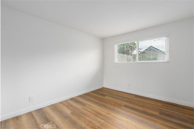 unfurnished room featuring dark hardwood / wood-style floors