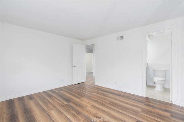 spare room with dark hardwood / wood-style floors