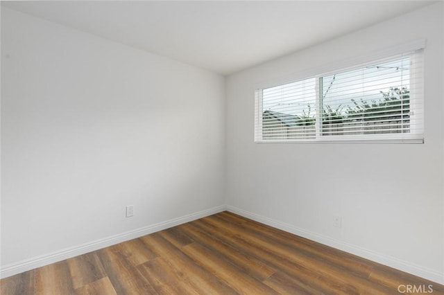 empty room with dark hardwood / wood-style floors