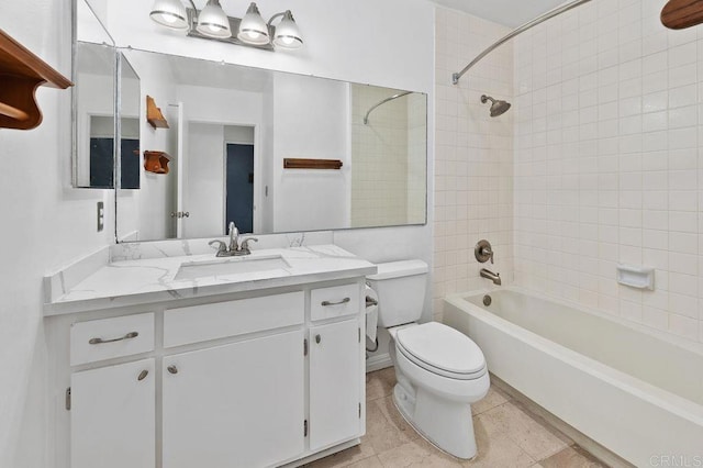 full bathroom with toilet, tile patterned flooring, tiled shower / bath, and vanity