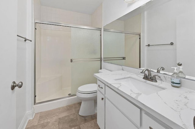 bathroom with a shower with shower door, toilet, and vanity