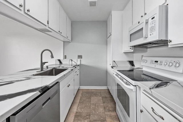 kitchen with white cabinets, sink, and white appliances