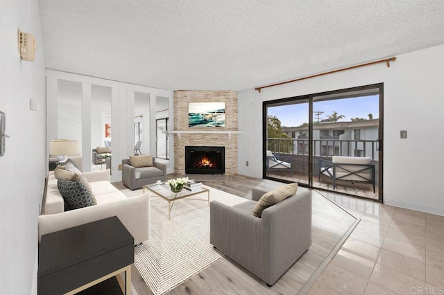 living area featuring a fireplace and a textured ceiling