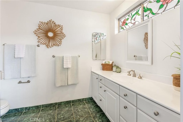 bathroom with toilet and vanity