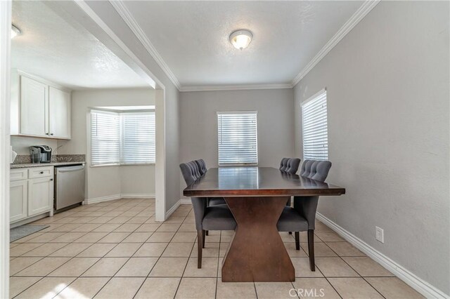 dining area featuring light tile patterned floors and ornamental molding