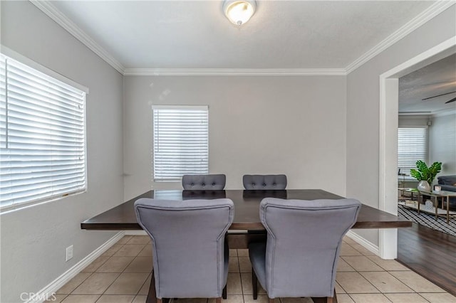 dining area featuring ceiling fan, light tile patterned floors, and ornamental molding