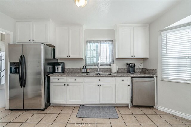 kitchen with sink, white cabinets, and stainless steel appliances