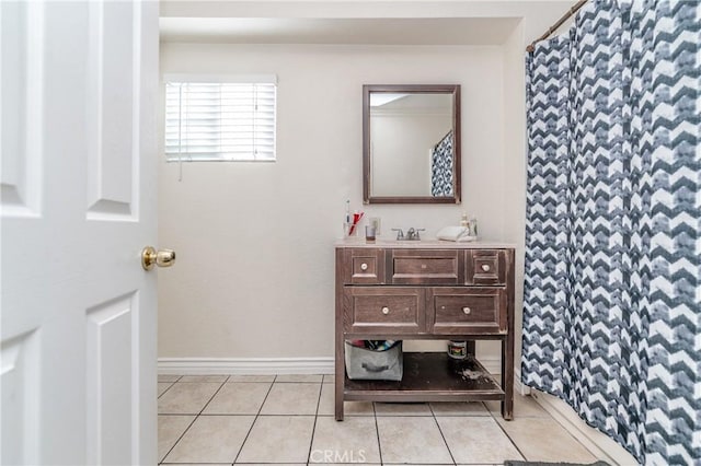 bathroom featuring curtained shower, vanity, and tile patterned flooring