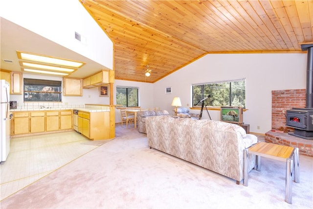 2206 Bernina Dr, Pine Mountain Club, CA 93222 - living area with a wood stove, healthy amount of natural light, light carpet, lofted ceiling, and wooden ceiling