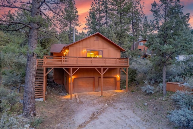 2206 Bernina Dr, Pine Mountain Club, CA 93222 - rustic home with dirt driveway, a garage, a deck, and stairway