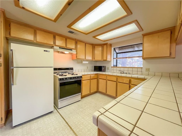 2206 Bernina Dr, Pine Mountain Club, CA 93222 - kitchen with white appliances, under cabinet range hood, tile countertops, a sink, and light brown cabinets