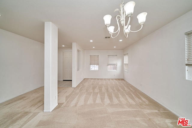 interior space with light carpet and an inviting chandelier