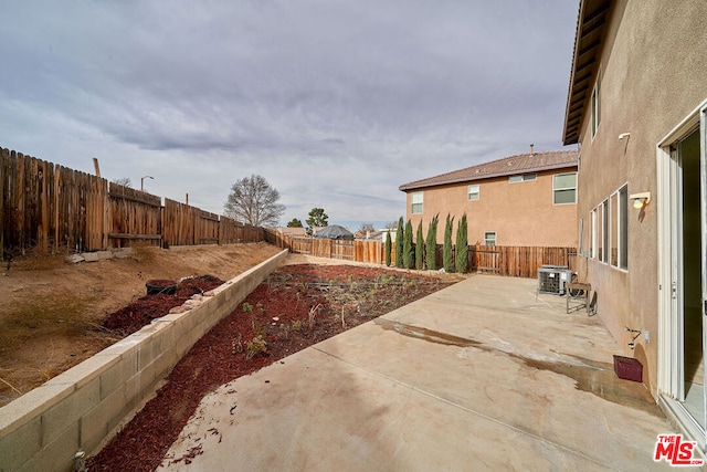 view of yard featuring a patio area and central air condition unit