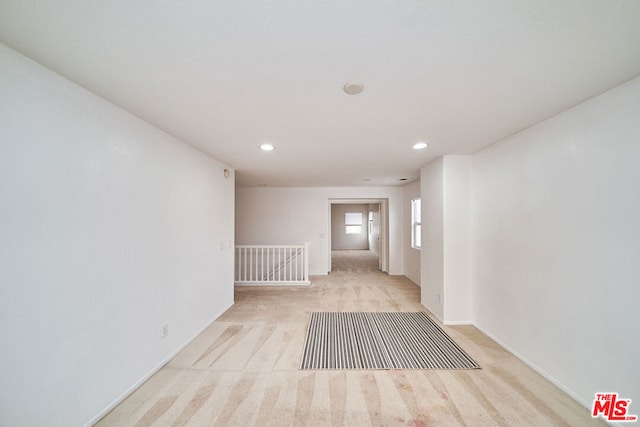 spare room featuring light colored carpet