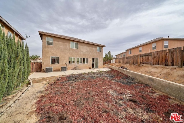 rear view of property featuring central AC and a patio