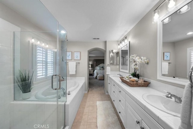 bathroom featuring tile patterned floors, vanity, and independent shower and bath