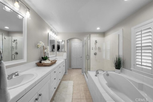 bathroom featuring tile patterned floors, vanity, plenty of natural light, and shower with separate bathtub