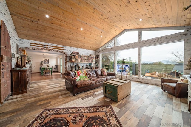 living room with high vaulted ceiling, hardwood / wood-style floors, and wood ceiling