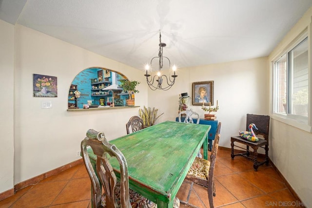 dining room with a chandelier and tile patterned floors