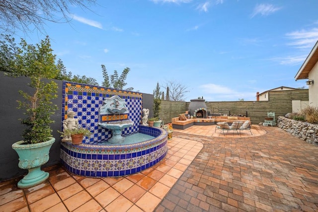 view of patio with an outdoor fireplace