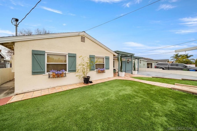 rear view of house with a yard