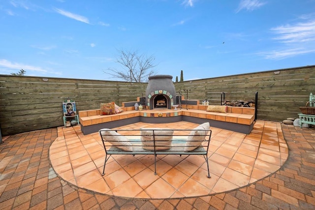 view of patio / terrace featuring an outdoor living space with a fireplace