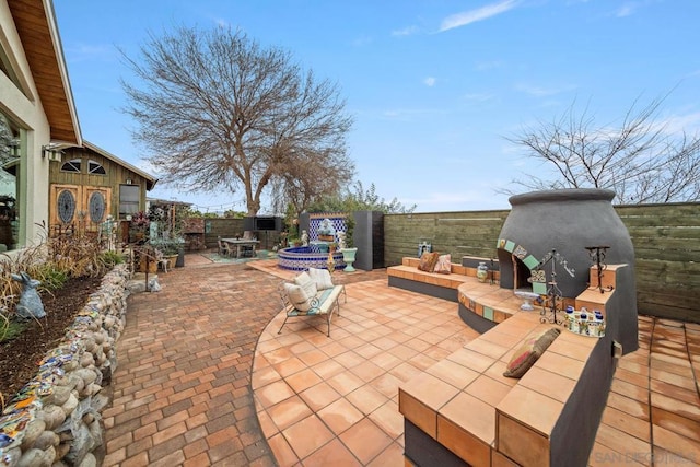 view of patio featuring an outdoor living space with a fireplace