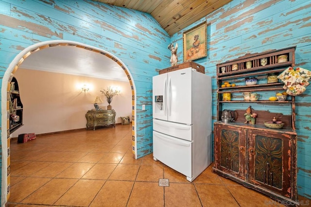 kitchen with light tile patterned flooring, wood ceiling, white refrigerator with ice dispenser, vaulted ceiling, and crown molding