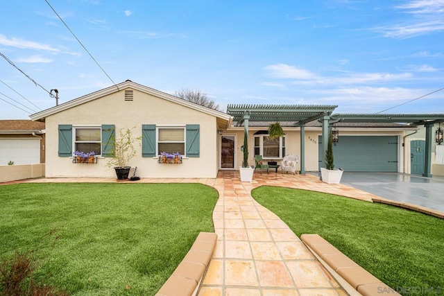 view of front of house with a front yard, a pergola, and a garage