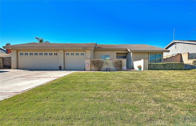 ranch-style home featuring a garage and a front lawn