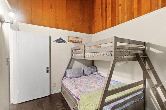 bedroom with dark hardwood / wood-style floors