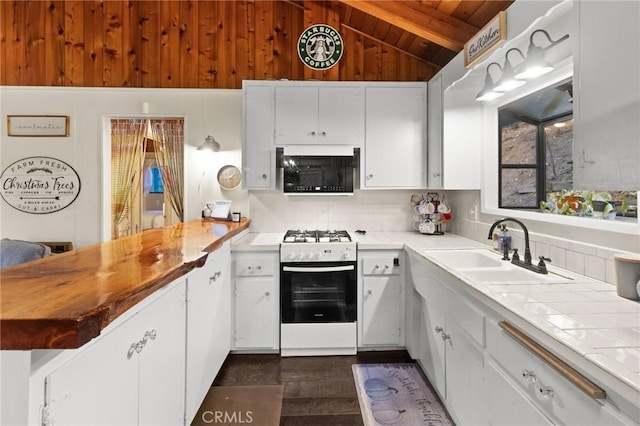 kitchen with lofted ceiling with beams, white stove, sink, white cabinetry, and wooden ceiling