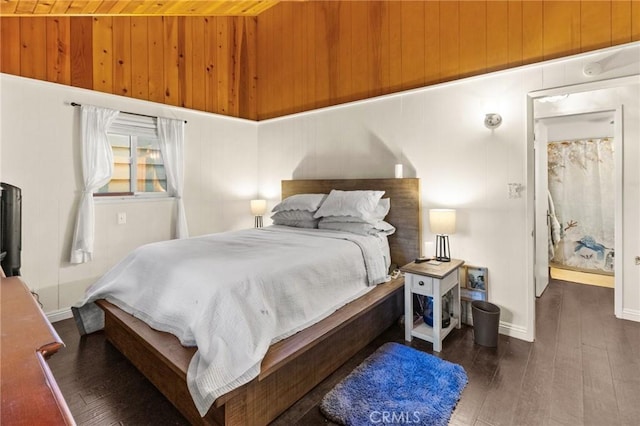 bedroom with wooden ceiling, dark hardwood / wood-style floors, and wooden walls