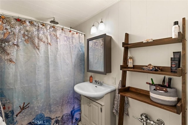 bathroom with ornamental molding, vanity, and curtained shower