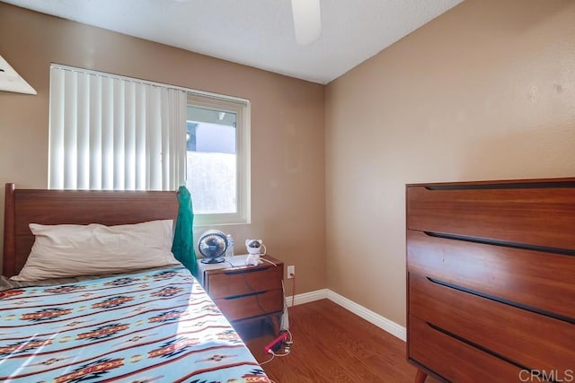 bedroom featuring ceiling fan and dark hardwood / wood-style floors