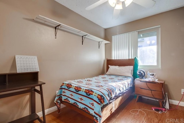 bedroom featuring ceiling fan and dark hardwood / wood-style floors