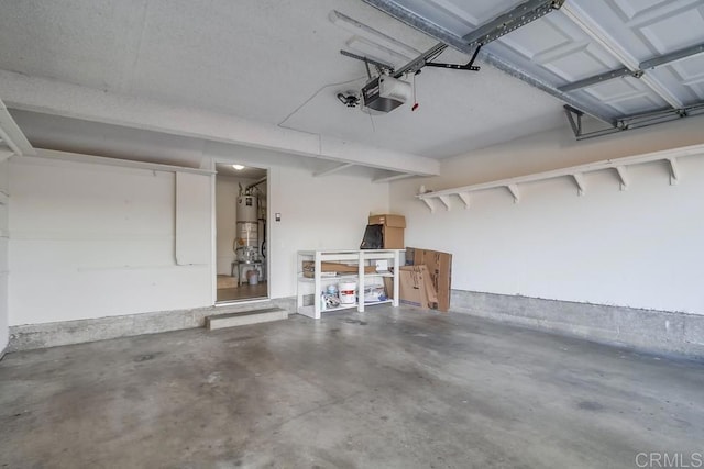 garage featuring a garage door opener and strapped water heater