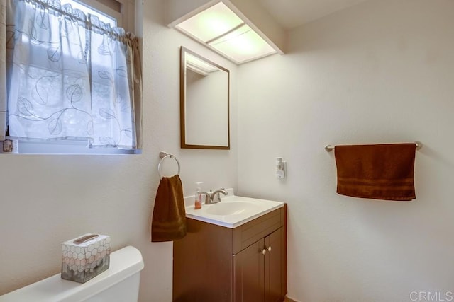 bathroom featuring toilet and vanity