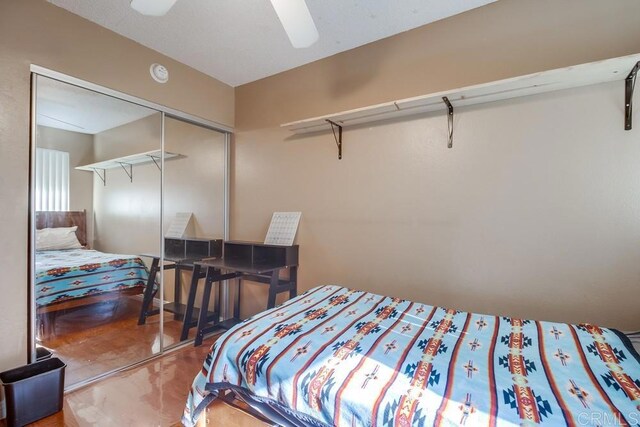 bedroom with ceiling fan and a closet